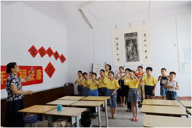 她在村里义务开了个国学堂班,照片为张晓慧教孩子学习《习主席寄语》手语表演.jpg